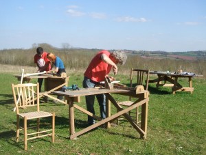 Hans cutting a mortice while JoJo and Fransisco squeeze together a chair frame 